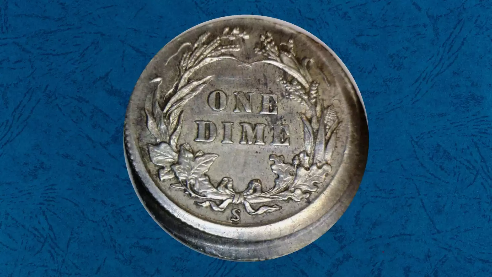 1902 Barber dime off-center strike showing partial design and blank planchet crescent